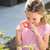 Girl in pink shirt looking through a Butterfly Magnifier